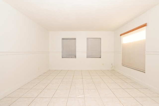 unfurnished room featuring light tile patterned flooring