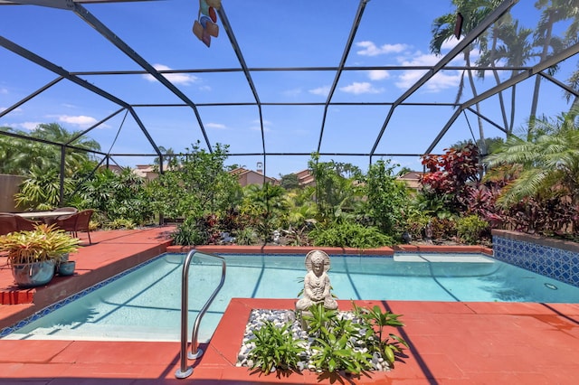 view of swimming pool featuring glass enclosure and a patio area