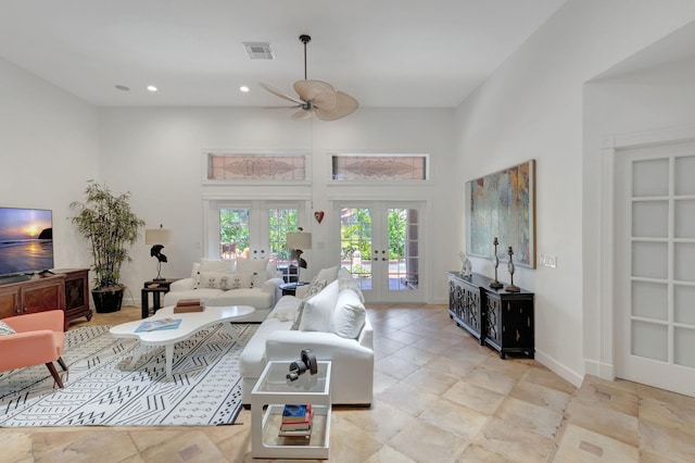 living room featuring french doors, ceiling fan, and a high ceiling