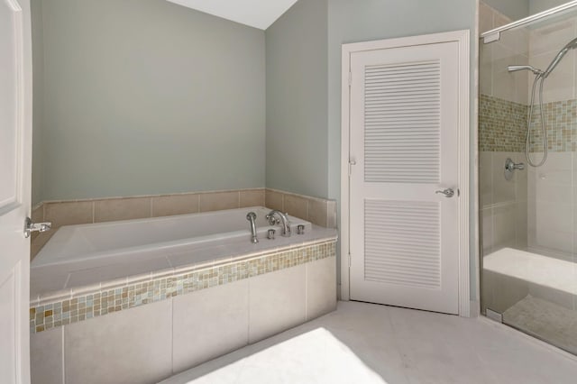 bathroom with tile patterned floors and independent shower and bath