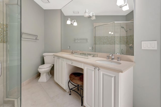 bathroom with tile patterned flooring, vanity, a shower with shower door, and toilet