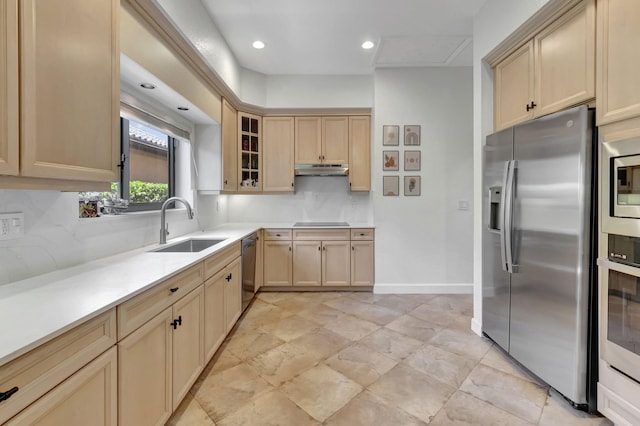 kitchen with decorative backsplash, sink, light brown cabinets, and appliances with stainless steel finishes