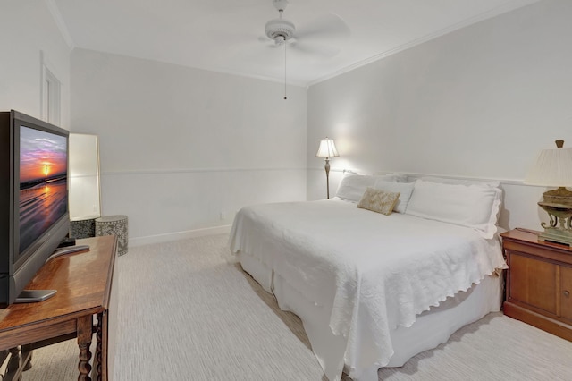 carpeted bedroom with ceiling fan and crown molding