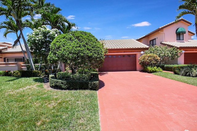 view of front facade with a garage and a front yard