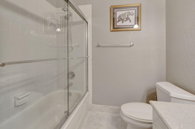 full bathroom with tile patterned flooring, vanity, toilet, and shower / bath combination with glass door