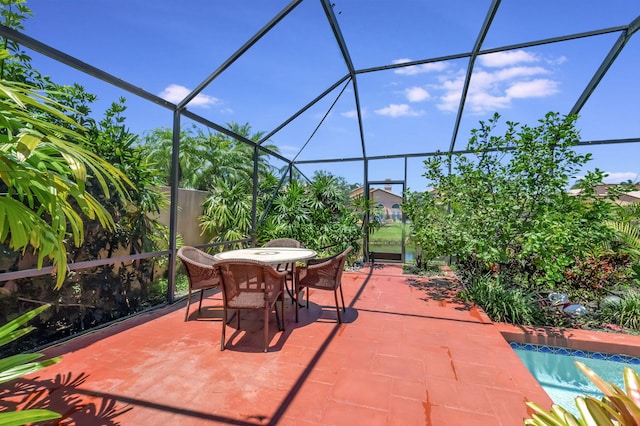 view of patio featuring a lanai