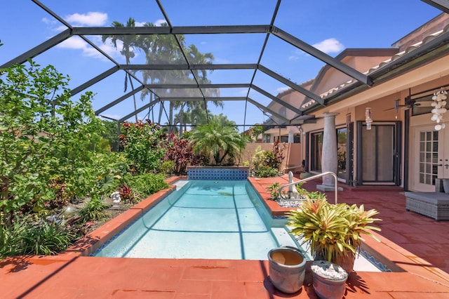 view of swimming pool featuring a lanai, ceiling fan, and a patio