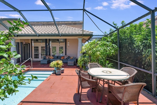 exterior space featuring outdoor lounge area, french doors, ceiling fan, and a lanai