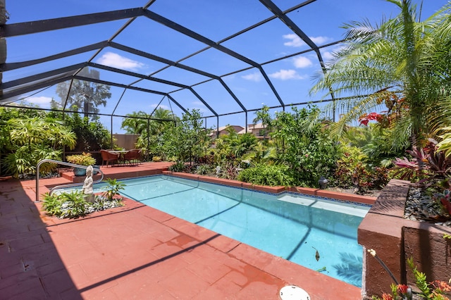 view of pool with a lanai and a patio