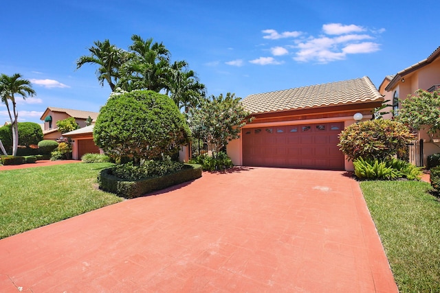 view of front facade featuring a front yard and a garage