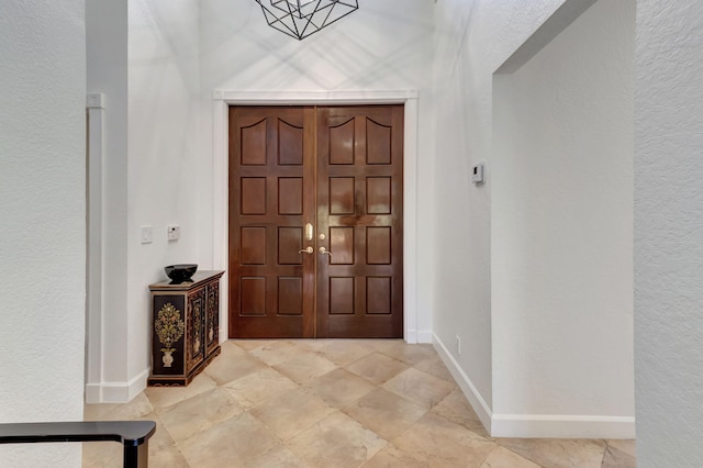 foyer with a chandelier