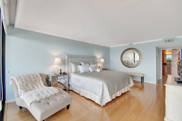 bedroom featuring light hardwood / wood-style floors and ornamental molding