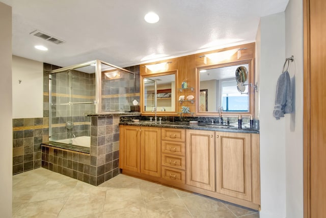 bathroom with tile patterned floors, vanity, and independent shower and bath