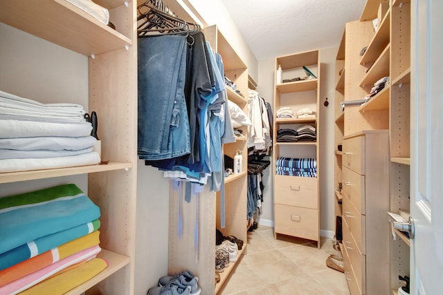 spacious closet with light tile patterned floors