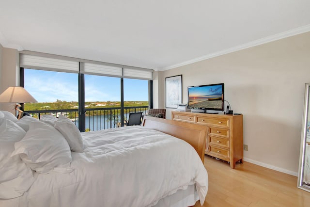 bedroom featuring access to outside, crown molding, and light hardwood / wood-style floors