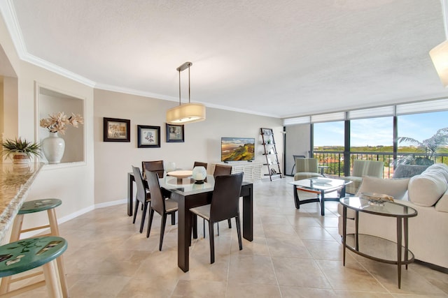 dining area with a textured ceiling, a wall of windows, and crown molding