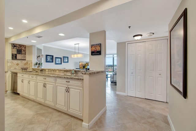 kitchen featuring kitchen peninsula, decorative backsplash, light stone countertops, decorative light fixtures, and dishwasher