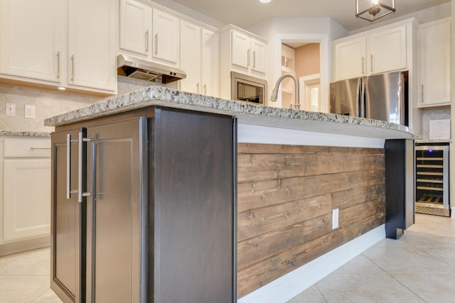 kitchen with white cabinets, stainless steel fridge, light tile patterned floors, and wine cooler