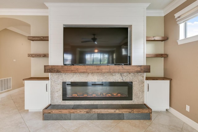 interior details featuring ceiling fan, built in features, and ornamental molding