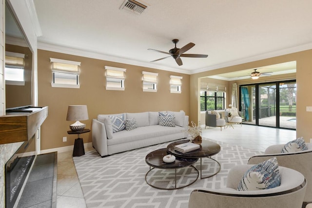 tiled living room featuring ceiling fan and crown molding