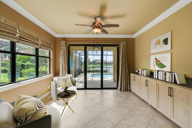 living area with ceiling fan, light tile patterned flooring, and ornamental molding