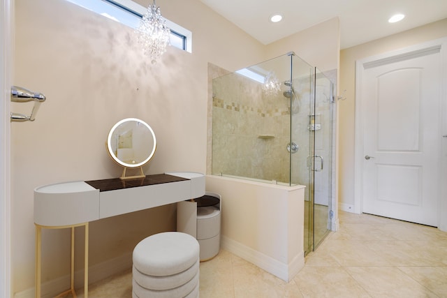 bathroom featuring a shower with door, tile patterned flooring, and an inviting chandelier