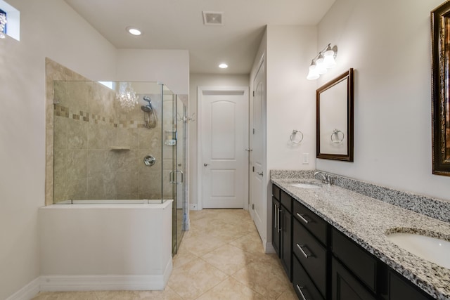 bathroom featuring tile patterned flooring, vanity, and a shower with shower door