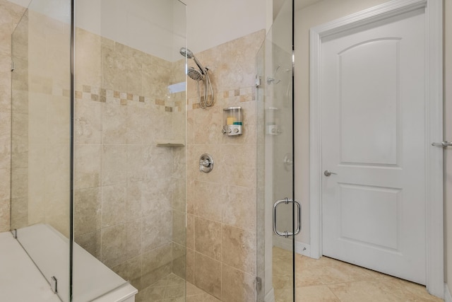 bathroom with a shower with door