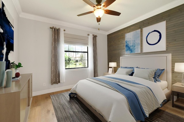 bedroom featuring hardwood / wood-style floors, ceiling fan, ornamental molding, and wood walls