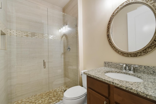 bathroom featuring vanity, toilet, and an enclosed shower