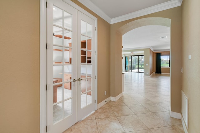 corridor featuring french doors, light tile patterned floors, and ornamental molding