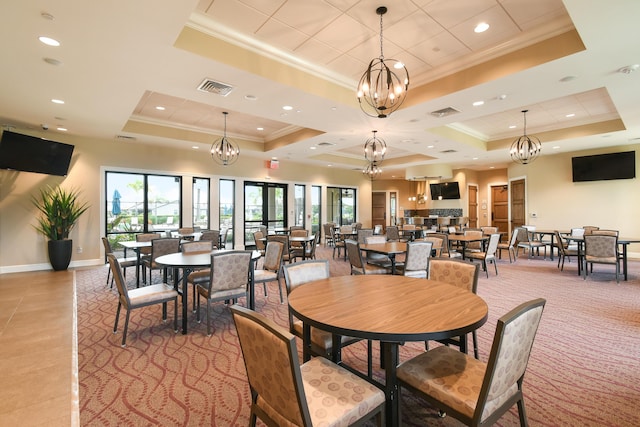 dining room with a raised ceiling and ornamental molding