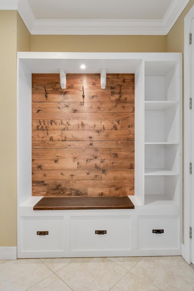 mudroom with light tile patterned floors and crown molding