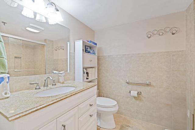 bathroom with walk in shower, vanity, tile walls, tile patterned flooring, and toilet