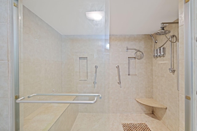 bathroom with a shower with shower door