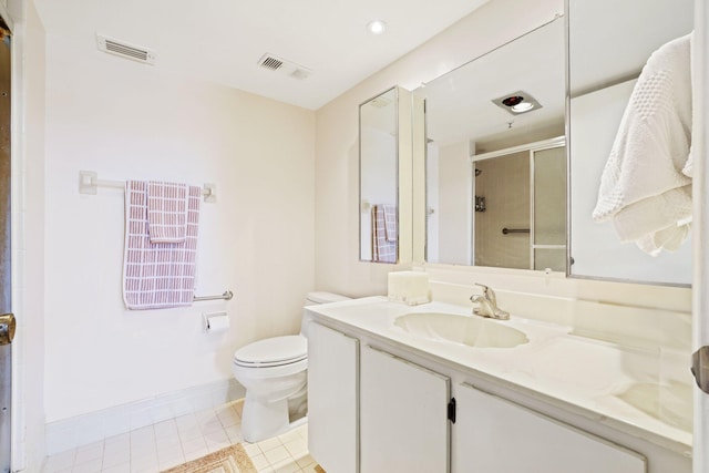 bathroom featuring tile patterned flooring, vanity, an enclosed shower, and toilet