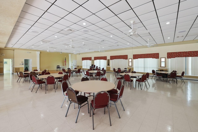 tiled dining room featuring ceiling fan