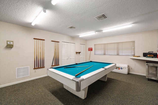 recreation room with dark colored carpet, a textured ceiling, and billiards