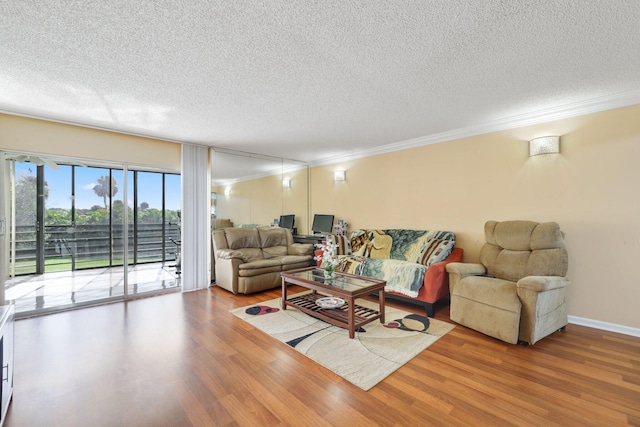 living room with ornamental molding, a textured ceiling, and hardwood / wood-style flooring