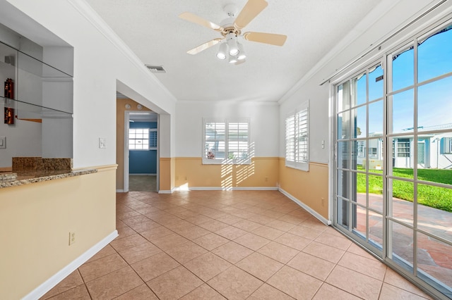 spare room featuring a textured ceiling, light hardwood / wood-style floors, and ceiling fan