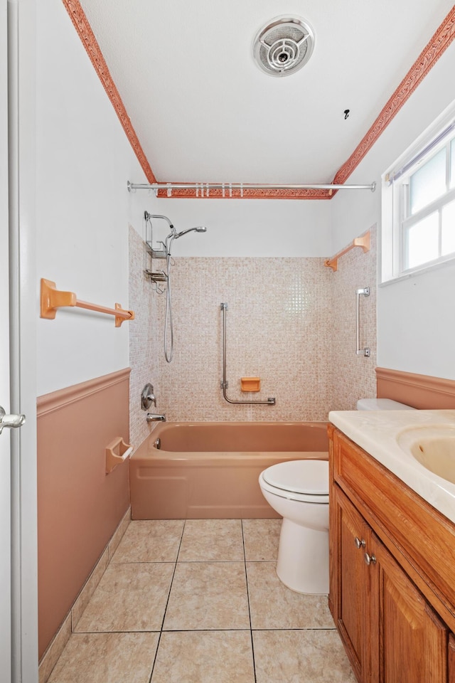 full bathroom with tile patterned flooring, vanity, a textured ceiling, and tiled shower / bath combo