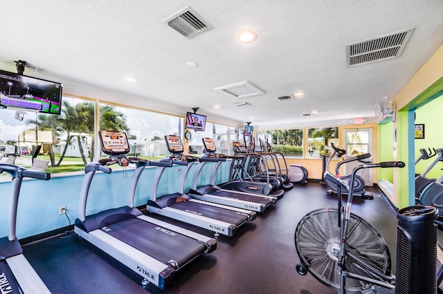 workout area featuring ceiling fan and a drop ceiling