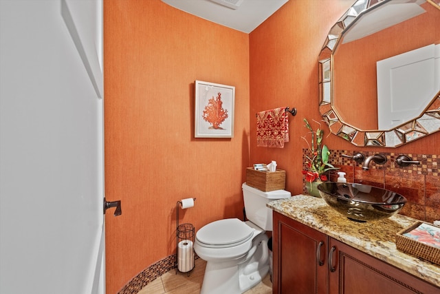 bathroom with toilet, wood-type flooring, and vanity