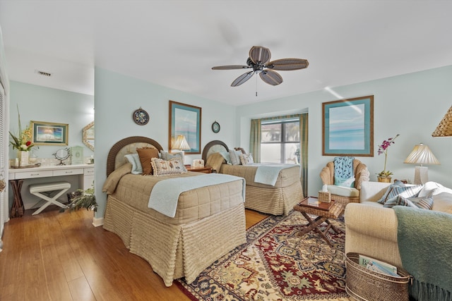 bedroom with ceiling fan and hardwood / wood-style floors