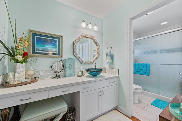 bathroom featuring toilet, vanity, tile patterned floors, and walk in shower