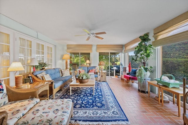 sunroom / solarium featuring ceiling fan