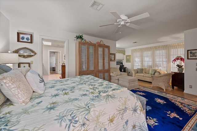 bedroom with ceiling fan and hardwood / wood-style flooring