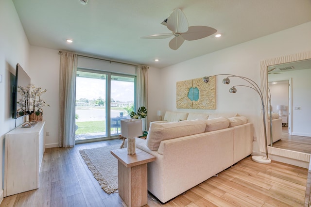 living room featuring ceiling fan and light wood-type flooring