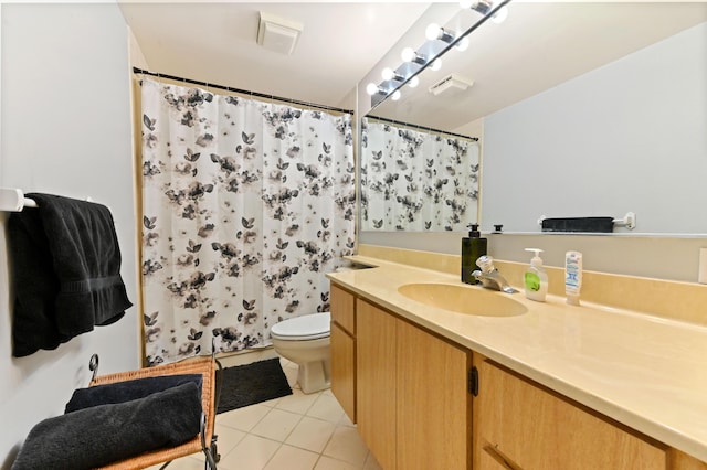 bathroom with tile patterned flooring, vanity, and toilet