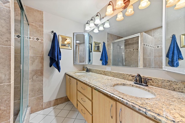 bathroom with tile patterned flooring, vanity, and walk in shower